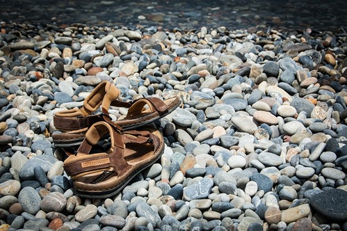 Image of sandals on a bed of stones 