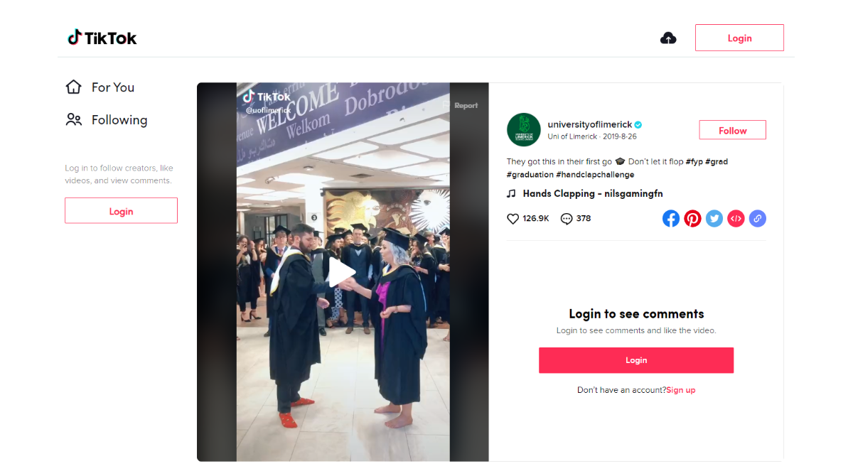 screen grab from tiktok account showing video of two graduates doing the handclap challenge